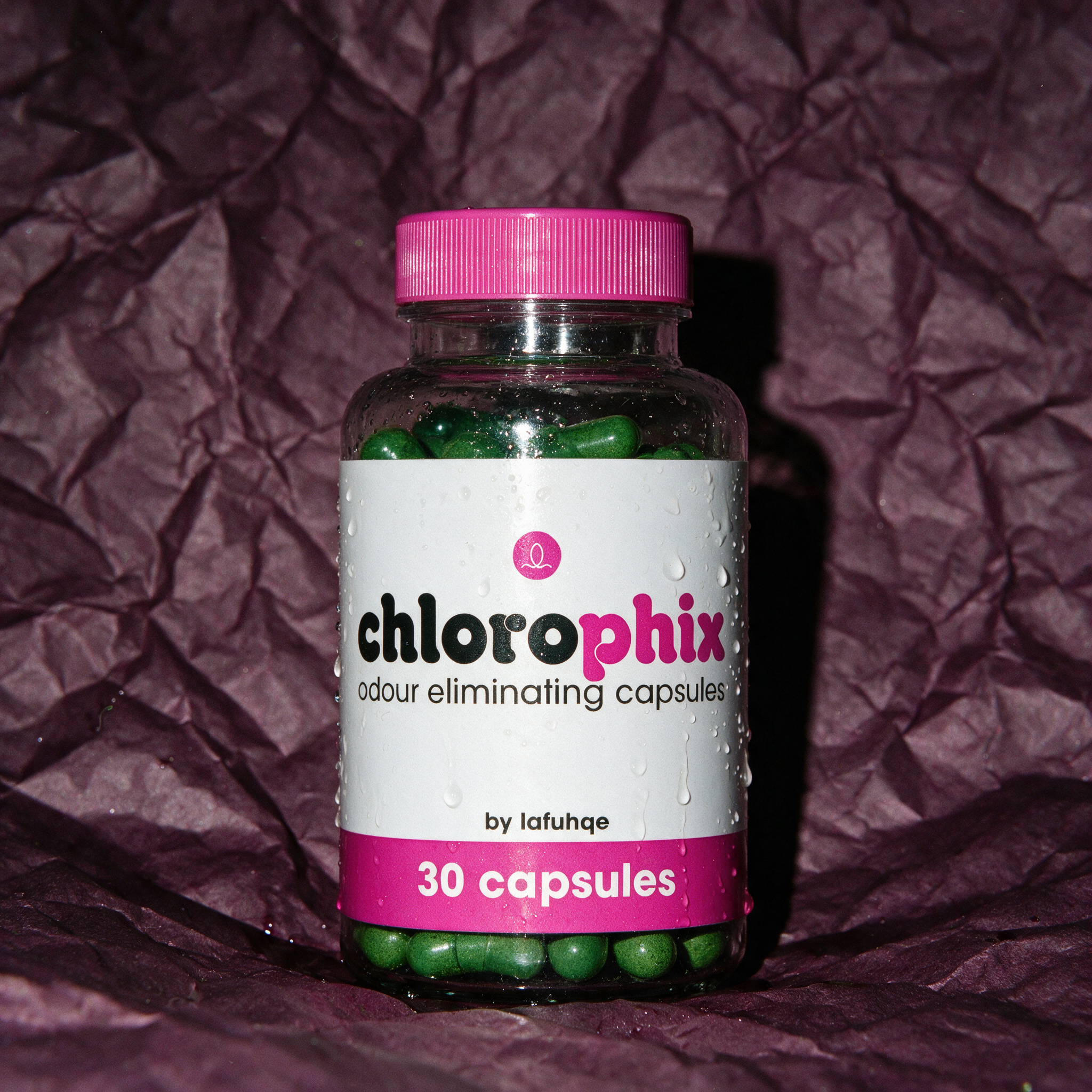 Chlorophix edible deodorizing capsules photographed on deep aubergine plum backdrop