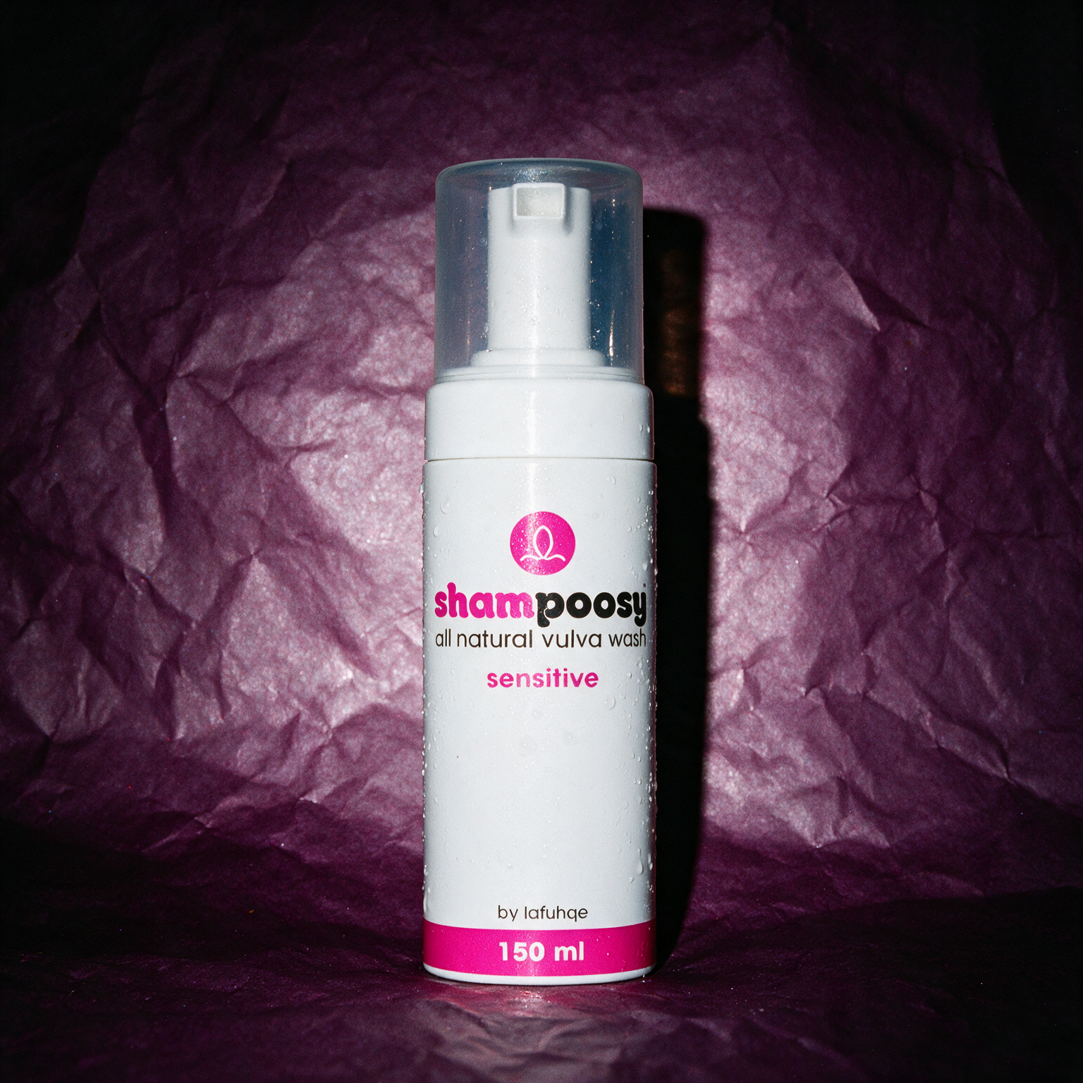 Shampoosy Sensitive vulva wash, white foamer bottle on deep plum crumpled paper